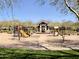 A delightful community playground featuring slides, climbing structures, and a charming pavilion at 9282 E Desert Vw, Scottsdale, AZ 85255