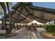 Community playground featuring a covered play area with various play structures, seating, and natural shade for outdoor fun at 9282 E Desert Vw, Scottsdale, AZ 85255