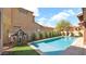 A backyard pool with turf and privacy landscaping on a sunny day at 9282 E Desert Vw, Scottsdale, AZ 85255