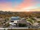 Expansive property featuring a pool, patio, and multiple buildings under a vibrant sunset sky at 103 W Tanya Rd, Phoenix, AZ 85086