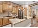 Warm kitchen with brick backsplash, central island, stainless steel appliances, and natural wood accents at 103 W Tanya Rd, Phoenix, AZ 85086