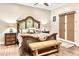 Rustic bedroom design with an ornate headboard, natural wood accents, and private patio access at 103 W Tanya Rd, Phoenix, AZ 85086