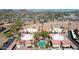 Expansive aerial view showcases a community nestled against a mountain backdrop with lush landscaping and vibrant community pool at 10410 N Cave Creek Rd # 1032, Phoenix, AZ 85020