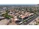 Expansive aerial view showcasing red-tile roofs across the community, nestled among desert flora and open roads at 10410 N Cave Creek Rd # 1032, Phoenix, AZ 85020