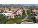 Aerial view of a well-maintained condo community with lush landscaping and a central creek at 10410 N Cave Creek Rd # 1032, Phoenix, AZ 85020