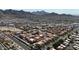 Extensive aerial view of red-tile rooftops amid desert vegetation, backed by a mountain range and city sprawl at 10410 N Cave Creek Rd # 1032, Phoenix, AZ 85020