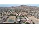 Broad aerial shot of a residential neighborhood with tile roofs, green spaces, tennis courts, and mountain views at 10410 N Cave Creek Rd # 1032, Phoenix, AZ 85020