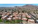 Sweeping aerial view of red-tile rooftops amongst desert landscaping, with imposing desert mountains in the distance at 10410 N Cave Creek Rd # 1032, Phoenix, AZ 85020