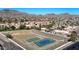 Expansive aerial view featuring community sports courts and red-tile roofs with a backdrop of desert mountains at 10410 N Cave Creek Rd # 1032, Phoenix, AZ 85020