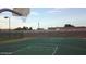 Outdoor basketball court with hoop and painted lines, set against a backdrop of desert foliage and distant buildings at 10410 N Cave Creek Rd # 1032, Phoenix, AZ 85020