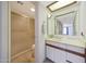 Bright bathroom featuring a shower, neutral tile flooring, and vanity with mirror at 10410 N Cave Creek Rd # 1032, Phoenix, AZ 85020