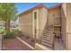 Exterior view of building with stairs leading to units and desert landscaping at 10410 N Cave Creek Rd # 1032, Phoenix, AZ 85020