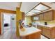 Kitchen with oak cabinets, laminate counters, and skylight offers ample space at 10410 N Cave Creek Rd # 1032, Phoenix, AZ 85020