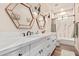 Bright bathroom with dual sinks, marble countertops, and decorative mirrors at 12216 S 214Th Ave, Buckeye, AZ 85326