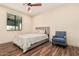 Cozy bedroom with a full bed and a comfortable chair at 12216 S 214Th Ave, Buckeye, AZ 85326