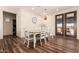 Bright dining room with a large wooden table and seating for eight at 12216 S 214Th Ave, Buckeye, AZ 85326