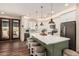 Eat-in kitchen featuring stainless steel appliances, a center island, and modern lighting at 12216 S 214Th Ave, Buckeye, AZ 85326