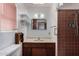 Small vintage bathroom featuring a single sink vanity, a shower, and a window for natural light at 1320 W Mariposa St, Phoenix, AZ 85013