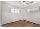 Bright bedroom boasts hardwood floors, neutral walls, and classic windows with white shutters at 1320 W Mariposa St, Phoenix, AZ 85013