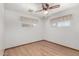 Bright bedroom featuring hardwood floors, white walls, and a ceiling fan at 1320 W Mariposa St, Phoenix, AZ 85013