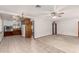 Open-concept living room seamlessly flows into a kitchen with white walls, fans, and tile flooring at 1320 W Mariposa St, Phoenix, AZ 85013