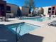 Community swimming pool and jacuzzi area with lounge chairs and clear blue water at 1340 N Recker Rd # 219, Mesa, AZ 85205