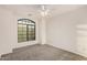 Bedroom with large window, carpeted floors, ceiling fan, and neutral colors at 13913 N 133Rd Dr, Surprise, AZ 85379