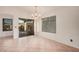 Dining area features tile flooring, sliding glass doors, and ample natural light at 13913 N 133Rd Dr, Surprise, AZ 85379