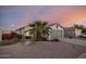 Single-story home featuring desert landscaping, a mature palm tree, and a two-car garage at 13913 N 133Rd Dr, Surprise, AZ 85379