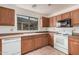 Well-lit kitchen with ample counter space, tiled floors, and white appliances at 13913 N 133Rd Dr, Surprise, AZ 85379