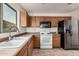 Bright kitchen featuring stainless steel refrigerator, microwave, and tiled flooring at 13913 N 133Rd Dr, Surprise, AZ 85379