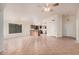 Open-concept living room with tile flooring, a ceiling fan, and natural light at 13913 N 133Rd Dr, Surprise, AZ 85379