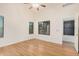 Sunlit primary bedroom with wood flooring, ceiling fan, and bright windows at 13913 N 133Rd Dr, Surprise, AZ 85379