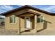 Front entrance features neutral brickwork and a covered porch, inviting entrance and curb appeal at 14024 W Noble Cir, Casa Grande, AZ 85122