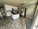 Well-lit kitchen with white cabinets, stainless appliances, and a center island for modern functionality at 14024 W Noble Cir, Casa Grande, AZ 85122