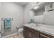 Modern bathroom with dark wood cabinets, white countertops, a sink, and gray walls at 14200 W Village Pkwy # 107, Litchfield Park, AZ 85340