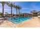 Sparkling pool with clear blue water surrounded by palm trees at 14200 W Village Pkwy # 107, Litchfield Park, AZ 85340