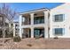 Exterior of a two-story home with balconies and desert landscaping at 14200 W Village Pkwy # 107, Litchfield Park, AZ 85340