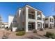 Exterior of a two-story home with balconies and desert landscaping at 14200 W Village Pkwy # 107, Litchfield Park, AZ 85340