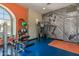 Bright fitness center with exercise equipment, accent wall and blue flooring at 14200 W Village Pkwy # 107, Litchfield Park, AZ 85340