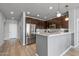 Bright kitchen featuring a stainless steel refrigerator, dark cabinets, white countertops, and a stylish backsplash at 14200 W Village Pkwy # 107, Litchfield Park, AZ 85340