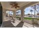 Outdoor patio with a ceiling fan, seating, and a view of palm trees at 14200 W Village Pkwy # 107, Litchfield Park, AZ 85340