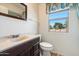 Bathroom features a single vanity with updated fixtures and a window providing ample natural light at 14215 N Boswell Blvd, Sun City, AZ 85351