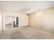 Bright bedroom features neutral carpeting, a ceiling fan, and sliding glass doors to the outdoors at 14215 N Boswell Blvd, Sun City, AZ 85351