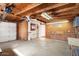 Spacious garage with exposed wood beams and ample storage space along the walls at 14215 N Boswell Blvd, Sun City, AZ 85351