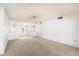 Spacious living room with neutral carpeting, ceiling fan, and bright white walls at 14215 N Boswell Blvd, Sun City, AZ 85351