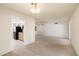 Bright, open living room leading to the kitchen with black appliances and ample natural light at 14215 N Boswell Blvd, Sun City, AZ 85351