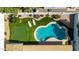 Aerial view of home's backyard featuring inviting pool, lounge chairs, lush landscaping, and putting green at 14433 N 37Th St, Phoenix, AZ 85032