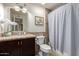 Bathroom with a modern vanity, granite countertops, stylish mirror and updated finishes at 14433 N 37Th St, Phoenix, AZ 85032