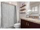 Bathroom with granite countertops, modern vanity, and stylish wood shelving for storage at 14433 N 37Th St, Phoenix, AZ 85032